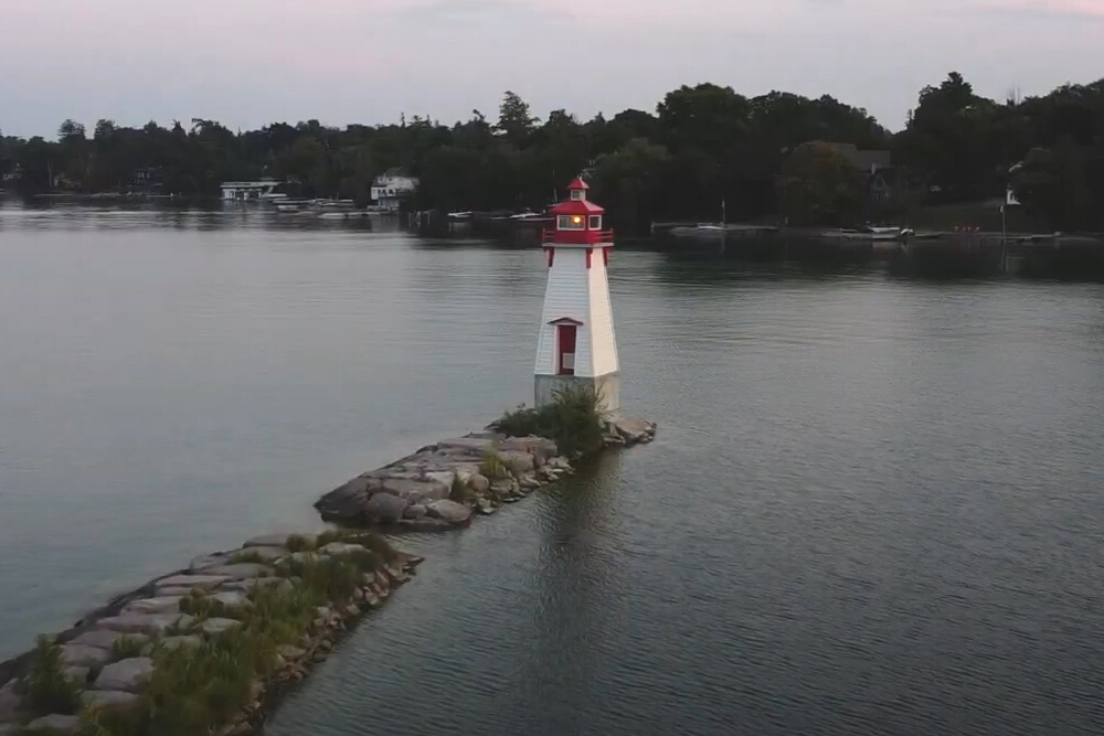 lighthouse on a piece of land in the lake